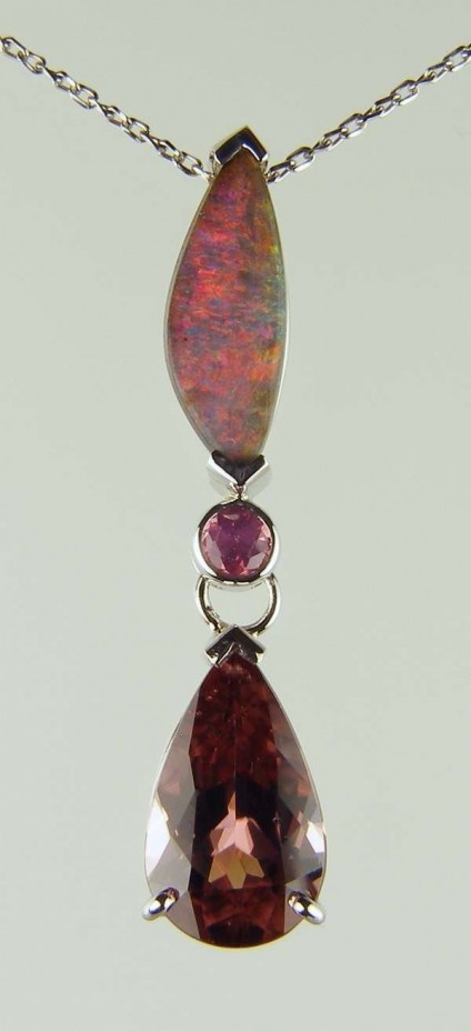 Opal, spinel & purple zircon pendant - 1.89ct boulder opal from Queensland, set with 0.19ct pink spinel round and 4.91ct pear cut pinkish brown-purple zircon in 18ct white gold and suspended from 18" 18ct white gold twisted trace chain