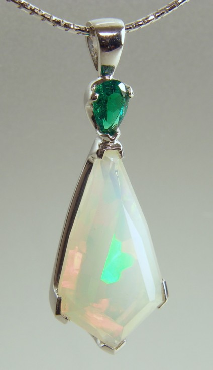 Opal & Emerald Pendant - Facetted Ethiopian opal 4.78ct set with 0.27ct pear cut Colombian emerald in 18ct white gold