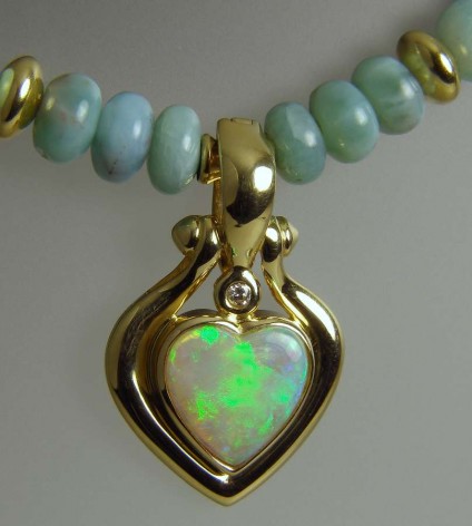 Opal Heart Pendant on Larrimar Beads - Cabochon heart cut solid opal from Australia, set with a diamond in 18ct yellow gold as pendant/enhancer on a necklace of 18ct yellow gold and larrimar beads
