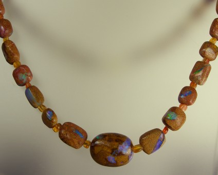 Opalised wood in sandstone necklace - Very rare opalised wood in sandstone bead necklace with 9ct yellow gold clasp. Necklace is 49cm long.