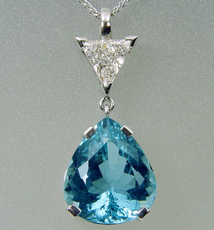Aquamarine & diamond pendant in gold - Pendant of 2.46ct trillion cut deep blue aquamarine set with certificated F/SI1, 0.9ct trillion cut diamond in 18 carat white gold. Pendant & 18 carat white gold chain. Pendant drop 25mm.
