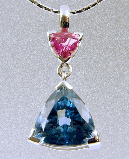 Aquamarine & pink sapphire pendant - Brazilian aquamarine and pink sapphire trillion pendant in 18ct white gold. 2.3cm long set with 2.46ct aquamarine and 0.44ct pink sapphire.