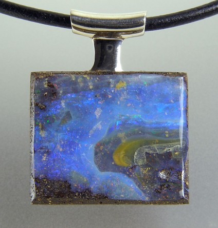 Boulder opal pendant in silver - Boulder opal pendant in silver on leather thong. Pendant 22x28mm.
