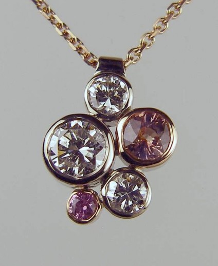 5 Stone Pink Sapphire & Diamond Pendant - 5.3ct and 0.11ct pink sapphires with a pair of 0.27ct diamonds and a 0.87ct diamond set in 18ct white and rose gold and suspendedn from a rose gold chain