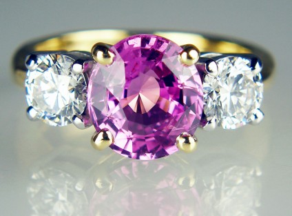 Pink sapphire & diamond ring in 18ct white & yellow gold - 2.72ct pink sapphire set with a 1.02ct matched pair of 0.51ct G colour VS2 clarity round brilliant cut diamonds in 18ct white and yellow gold.  This ring was created using the solitaire diamond and shank of the customer's original engagement ring and was to mark a significant wedding anniversary.  

Just Gems is expert at remodelling jewellery, reusing original gems and gold, and making something truly splendid to celebrate the major milestones in life!