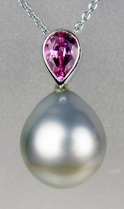Pink sapphire & Tahitian pearl pendant in 18ct white gold - 0.84ct pink sapphire set with silvery coloured drop shaped Tahitian pearl mounted in 18ct white gold and suspended from an 18ct white gold chain. Pendant measures 22mm long