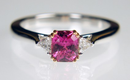Pink sapphire & trillion cut diamond ring in rose & white gold - 0.95ct radiant cut pink sapphire set in 18ct rose gold and flanked by 0.12ct G/VS quality, trillion cut diamond pair mounted in 18ct white gold