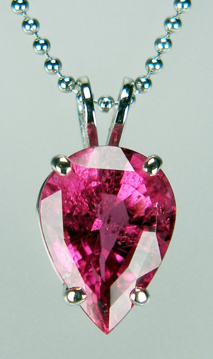 Pink tourmaline pear cut pendant in platinum  - 3.93ct pear cut faceted hot pink tourmaline, claw set in platinum and suspended from a 16" platinum chain. This item and the chain are included in our 20 year anniversary sale and now cost £747.5