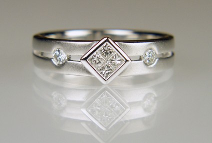 Princess cut diamond ring in frosted white gold - 0.24ct of princess cut and round brilliant cut diamonds in H colour VS clarity and set in a satin and polished 18ct white gold ring