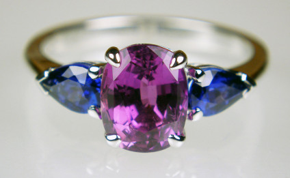 Purple & blue sapphire ring in 18ct white gold - 2.62ct cushion cut magenta sapphire , set with a 0.85ct matched pair of pear cut blue sapphires in 18ct white gold