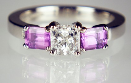 Purple sapphire & diamond ring - 0.50ct square radiant cut diamond D colour VS2 clarity with GIA report, flanked by a matched pair of 0.95ct emerald cut natural purple sapphires and a 0.035ct pair of princess cut diamonds, mounted in platinum.