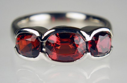 Red spinel & palladium ring - 3 stone cushion cut red spinels from Myanmar set in palladium.  Central stone is 1.74ct and the flanking pair of cushion cuts are 2.20ct in weight.