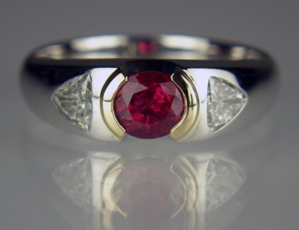 Ruby & diamond ring in platinum - 0.82ct oval cut natural ruby set with a 0.52ct pair of trillion cut diamonds in 18ct yellow gold and platinum