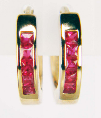 Ruby huggie earshoops in 9ct yellow gold - Cute and practical ruby huggie earhoops in 9ct yellow gold. Earhoops are fully circular and measure 15mm outside diameter. They contain 0.40ct of princess cut fine quality rubies. These earhoops are included in our 20 year anniversary 50% sale and now cost £297.50