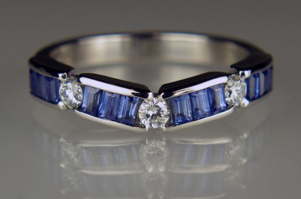 Sapphire & diamond ring in platinum - Round brilliant cut diamonds totalling 0.2ct in F colour VS clarity set off the brilliant blue of 0.98ct baguette cut sapphires in this gently curving handmade ring in platinum, designed to fit around the customer's platinum and diamond 3 stone engagement ring.