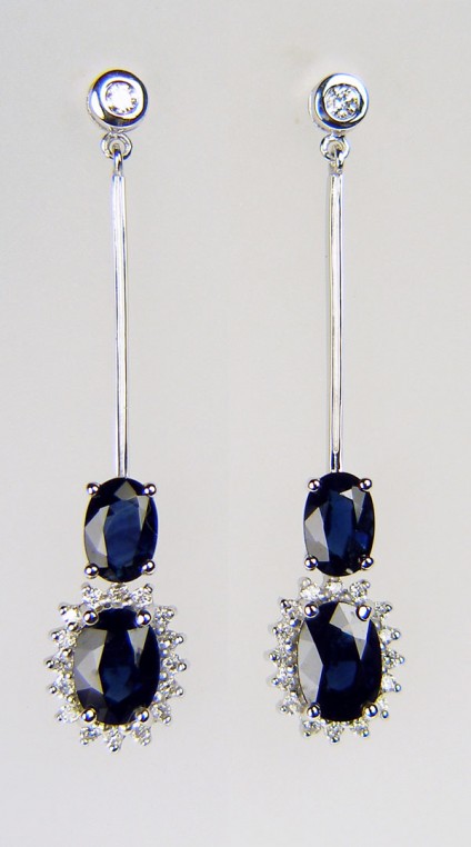 Sapphire & diamond earrings - Elegant drop sapphire & diamond earrings in 9ct white gold. Two matched oval sapphire pairs totalling 2.0ct and surrpunded by 30pts of round brilliant cut diamonds. The rubover set studs are set with a 15pt matched diamond round brilliant cut pair. The earrings are 40mm total length.