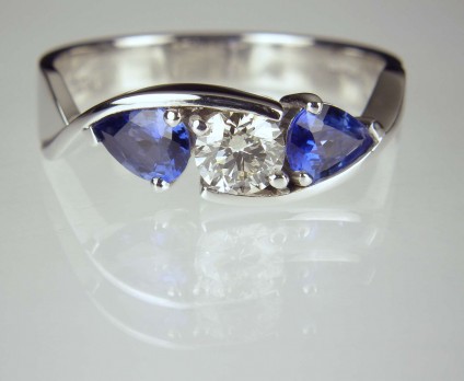 Sapphire & Diamond Twist Ring - Round brilliant cut diamond 0.42ct set with a matched pair of pear cut sapphires totalling 0.8ct mounted in platinum