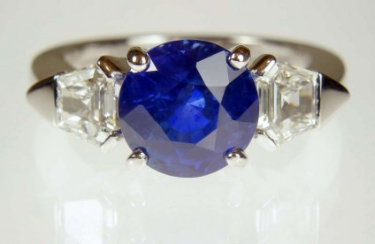Sapphire & diamond ring in platinum - 4.1ct round sapphire of exceptionally fine colour, set with a 0.63ct matched pair of G colour VS1 clarity taper cut diamonds in platinum