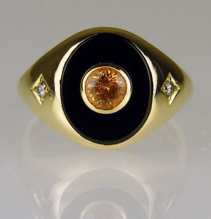 Man's onyx signet ring set with mandarin garnet - Onyx signet ring in 9ct yellow gold. This ring belonged to a customer's father and she wanted to feminise it to wear as a keepsake after he had passed away. Just Gems drilled the onyx and set it with a lively mandarin spessartine garnet (the father's birthstone). 