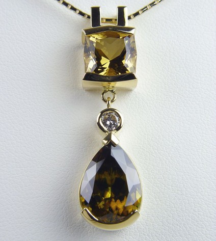 Sphene, diamond & golden beryl pendant in gold - Sphene, golden beryl & diamond Pendant. Pendant of 6.04ct pear shaped sphene set with 3.13ct radiant cut golden beryl and 0.2ct diamond in 18 carat yellow gold. 40 x 10mm.
