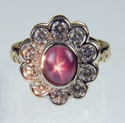 Star sapphire & diamond ring - 2.29ct oval star pink sapphire set with 1.25ct white diamonds in platinum & 18ct yellow gold