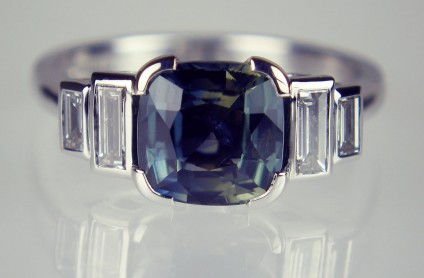 Teal sapphire & diamond ring in 18ct white gold - 1.88ct teal coloured cushion cut natural sapphire flanked by two pairs of baguette cut diamonds totalling 0.16ct and 0.10ct respectively.  The diamonds are graded as F colour VS clarity.