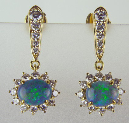 Black opal drop earrings in 18ct gold - Black opal cabochons surrounded by diamonds and suspended from a line of graduated diamonds, total diamond weight 1.50ct, diamond quality G colour VS clarity, all in 18ct yellow gold