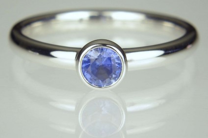 Sapphire Ring - 0.3ct round brilliant cut mod blue sapphire in delicate rubover set white gold ring