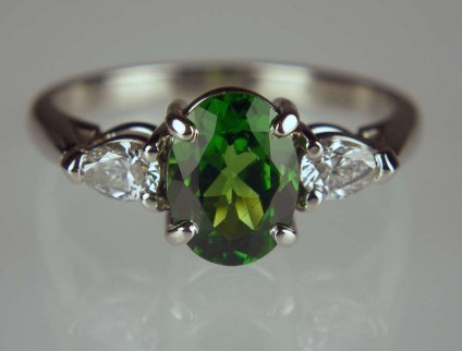Tsavorite garnet & diamond ring in palladium - 1.49ct oval tsavorite garnet set with 0.28ct pair of pear cut diamonds in palladium
