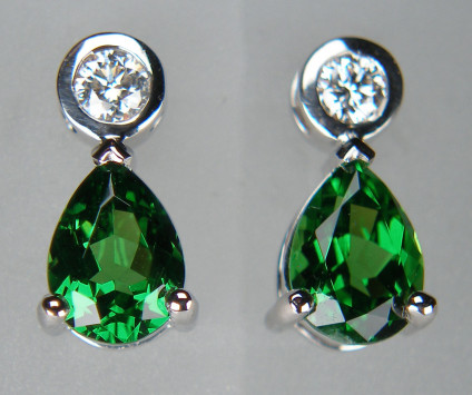 Tsavorite garnet & diamond earrings in 18ct white gold - Bright and sparkly green garnet (tsavorite) pair weighing 1.6ct, suspended from rubover set round brilliant cut diamonds in F colour SI clarity 0.17ct total diamond weight in 18ct white gold earrings