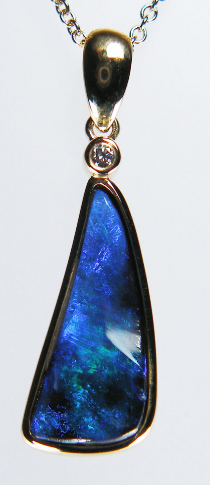 Winton boulder opal & diamond pendant in 9ct yellow gold - Pretty blue and green triangular solid boulder opal from Winton, Queensland, suspended from a small round brilliant cut diamond and rubover set in 9ct yellow gold. Pendant is 29.5mm long. The chain is available for separate purchase.