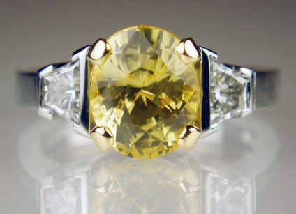 Yellow sapphire & diamond ring in platinum - 4.09ct oval yellow sapphire, natural and unheated, set with a matched pair of 0.62ct trapeze cut diamonds in G colour VS clarity, mounted in platinum