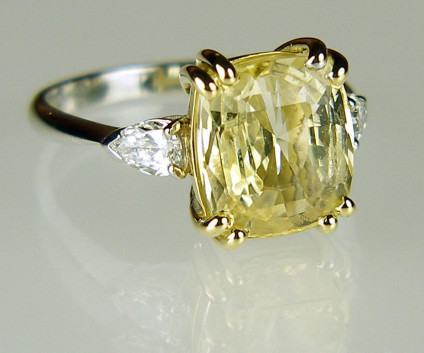 Yellow sapphire & diamond ring in 18ct yellow & white gold - 5.24ct natural yellow sapphire, unheated, cushion cut and flanked by a 0.41ct matched pair of pear cut diamonds in F colour VS clarity and mounted in 18ct yellow and white gold.

