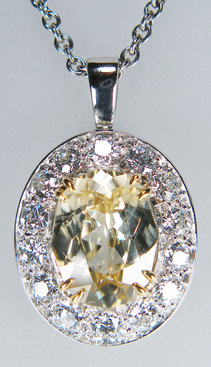 Natural yellow zircon & diamond pendant in platinum - 8.73ct oval yellow zircon, highly dispersive and looking just like a yellow diamond, surrounded by 2.25ct of G colour VS clarity round brilliant cut diamonds, mounted as a pendant in platinum. Pendant is 29 x 19mm. Pendant is suspended from a 20" adjustable to 16" & 18" platinum trace chain. Chain is £960, pendant is £9995